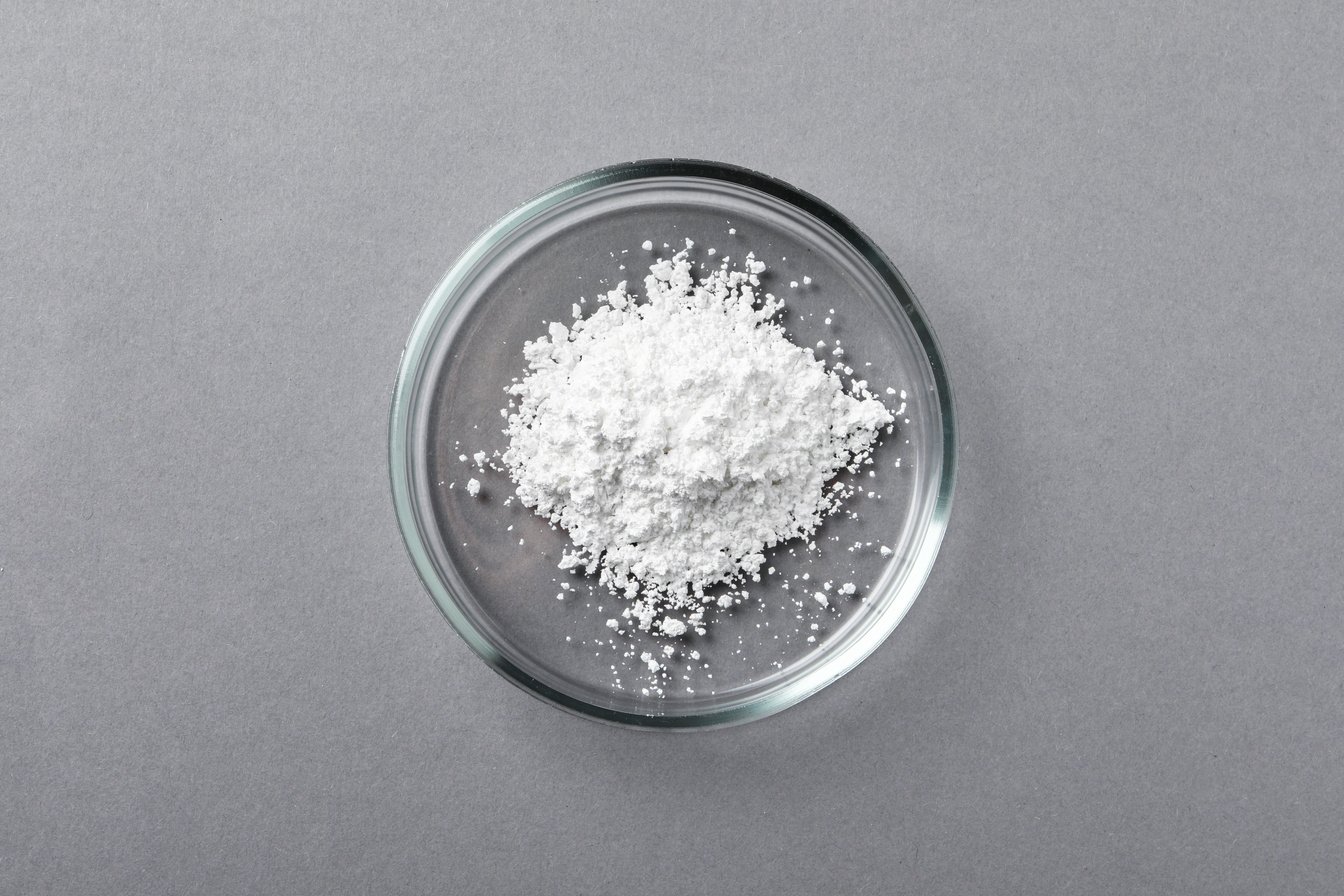 Petri Dish with Calcium Carbonate Powder on Grey Table, Top View