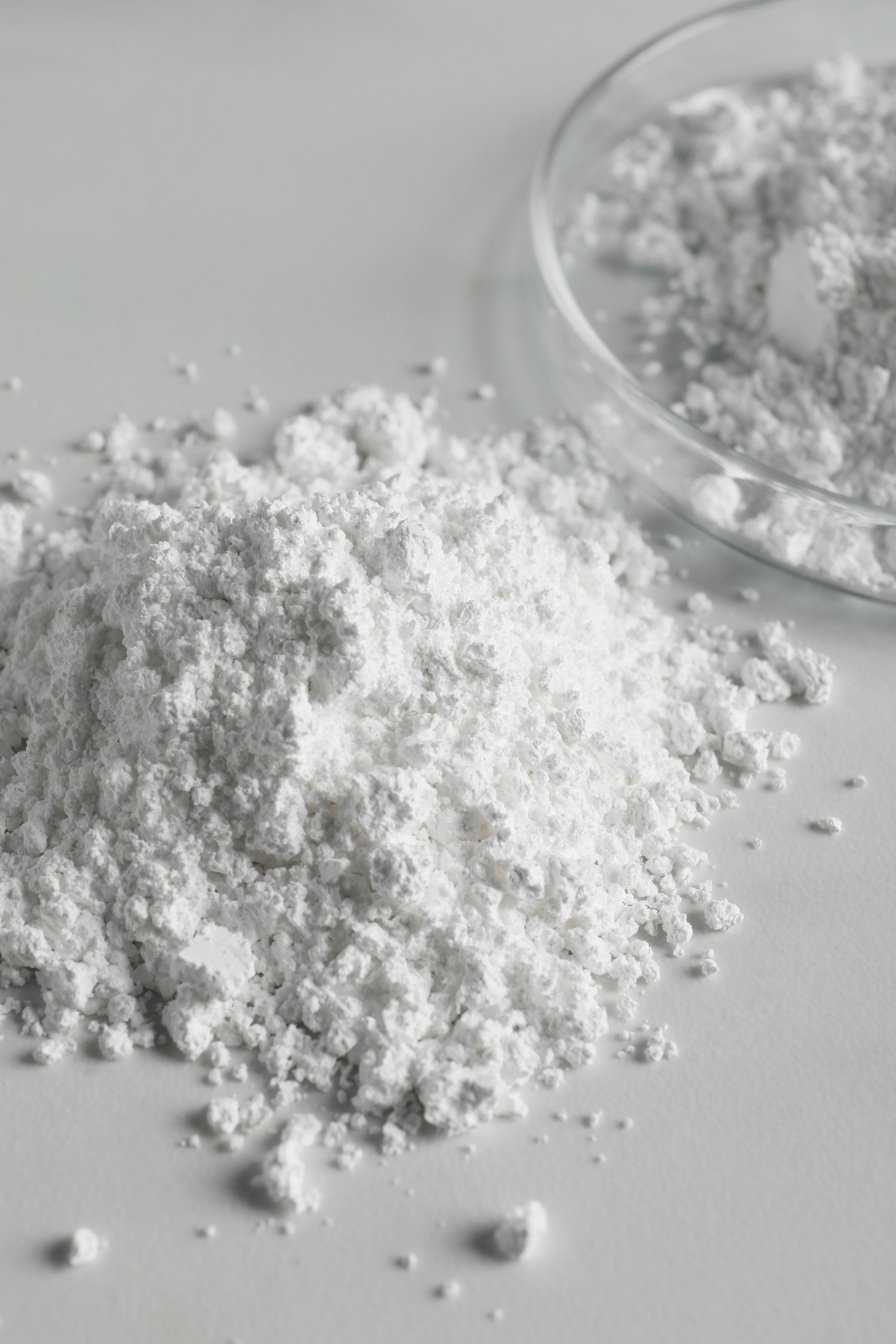 Heap of Calcium Carbonate Powder on White Table